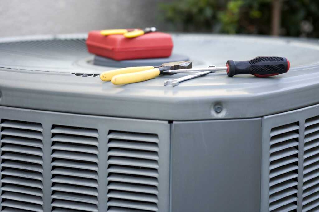 Closeup of condenser unit with tools